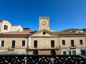 a building with a clock tower on top of it at Luxury Apartment in Crotone
