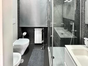 a bathroom with a toilet and a sink and a shower at Luxury Apartment in Crotone