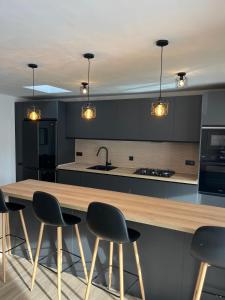 a kitchen with a wooden counter and chairs in it at Villa Palma Cabo Roig 31a in Orihuela Costa