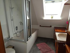 a bathroom with a shower and a sink at Ferienwohnung Jansen in Ostrhauderfehn +26 photos