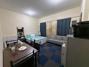 a living room with a couch and a table at Ghurfati in Abu Dhabi