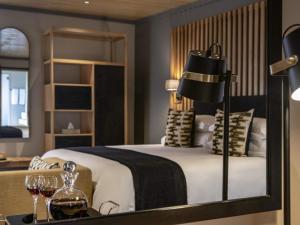 a bedroom with a bed and two glasses of wine at Founders Lodge by Mantis in Paterson +136 photos