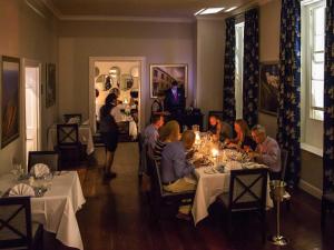 a group of people sitting at tables in a restaurant at Mantis St Helena in Jamestown