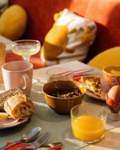 芒通Hôtel Gabriel的餐桌上放有食物和橙汁的盘子