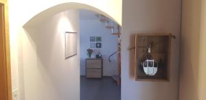 a hallway with an archway with a purse hanging in it at Ferienhaus Fisch in Bad Ragaz