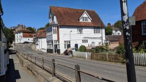 a white house on the side of a street at St Davids House in Cranbrook