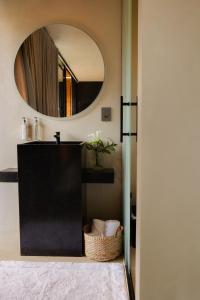 a bathroom with a mirror and a sink at Bowi Hotel Conceito in Tiradentes +31 photos