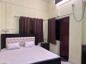 a bedroom with a large bed with white sheets at Kashiyana in Varanasi +27 photos