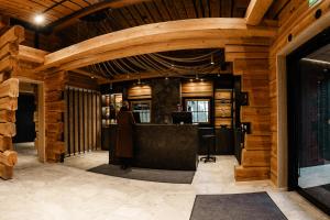 a bar in a room with wooden walls at Vaattunki Wilderness Resort in Rovaniemi +48 photos