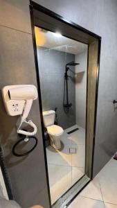 a bathroom with a toilet and a phone at شقة مفروشة apartment amman alnuzzha in Amman