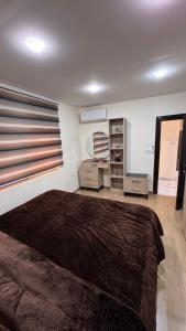 a bedroom with a large bed and a window at شقة مفروشة apartment amman alnuzzha in Amman