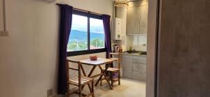 a kitchen with a table and a large window at EmBruHadas Violet in San Salvador de Jujuy +7 photos