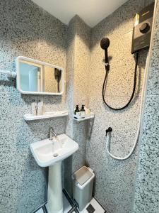 a bathroom with a sink and a shower and a toilet at Patong Beach Verve in Patong Beach