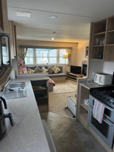a kitchen and living room with a couch in the background at Horizon Bay in Longniddry