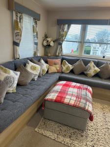 a blue couch with pillows in a living room at Horizon Bay in Longniddry