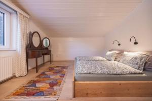 a bedroom with a bed and a dresser and a piano at Katja's Loft in Neustift im Stubaital