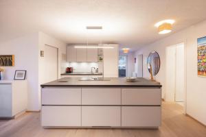 a kitchen with white cabinets and a counter top at Katja's Loft in Neustift im Stubaital