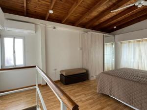 a bedroom with a bed and a stool in it at Raíces Pampas in Azul