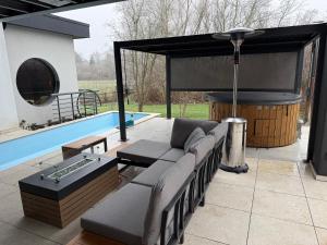 a patio with a couch and a swimming pool at Wellness Oase in Paderborn