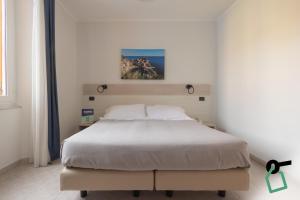 Postel nebo postele na pokoji v ubytování Hotiday La Spezia Centrale