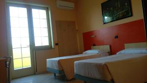 Postel nebo postele na pokoji v ubytování La Quercia Hotel con Ristorante