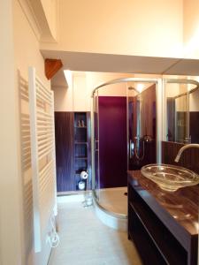 a bathroom with a glass sink and a shower at Haus Waldesruh - Eventhotel in Schönewalde +60 photos