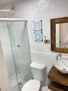 a bathroom with a shower and a toilet and a sink at BOSQUE TOQUE TOQUE Pousada in São Sebastião +62 photos