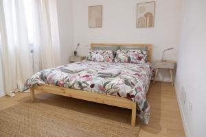 a bedroom with a bed with a floral bedspread at La Casa del Borgo in Rieti