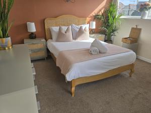 a bedroom with a large bed with white sheets and pillows at Eyre Court Hotel in Seaton