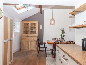 a kitchen and dining room with a table and chairs at Park Cottage in Kingsbridge