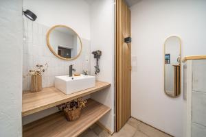 een badkamer met een wastafel en een spiegel bij Algarvia in Parchal +31 foto's