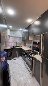 a kitchen with stainless steel cabinets and a stove at شقة مفروشة apartment amman alnuzzha in Amman +11 photos