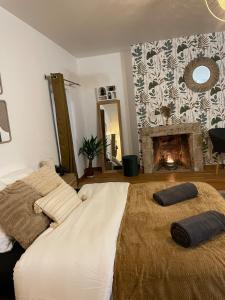 a bedroom with a bed with a fireplace in it at Cozy & Stylish, hyper center in Quimper