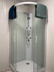 a shower with a glass door in a bathroom at Cozy & Stylish, hyper center in Quimper