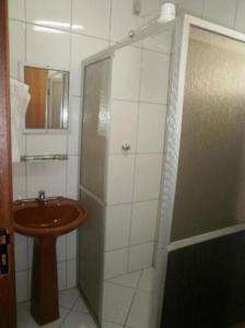 a small bathroom with a sink and a shower at Rede Andrade Porto Mar in Maceió