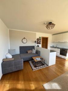 a living room with a couch and a table at Apartment Steinernes Meer inklusive Saalfelden Leogang Card in Saalfelden am Steinernen Meer +6 photos