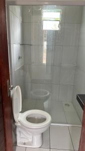a bathroom with a toilet and a shower at Pousada por do sol in Monte das Gameleiras