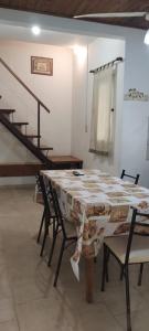 a table and chairs in a room with a staircase at Cabañas de Itacú in Chajarí +35 photos
