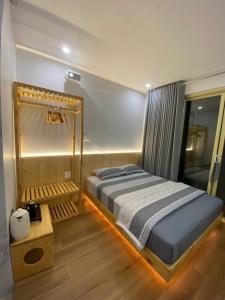 a bedroom with a large bed and a wooden floor at Kỳ Duyên House in Cái Răng