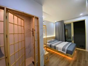 a bedroom with a bed and a sliding door at Kỳ Duyên House in Cái Răng +15 photos