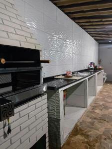 a kitchen with a long counter in a room at Pousada Vale Do Aijalom in Cabo Frio