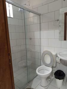 a bathroom with a toilet and a glass shower at Hotel BLESS in Cascavel +34 photos