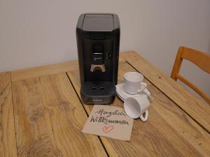a coffee maker on a table with a happy anniversary sign at elfA-partment in Schwanstetten