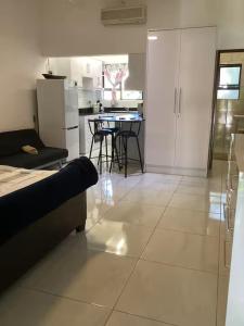 a kitchen and living room with a table and chairs at Unit 5 Manzini Chalet in St Lucia