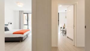 a bedroom with a bed and a room with a desk at Lisbon Serviced Apartments - Parque in Lisbon