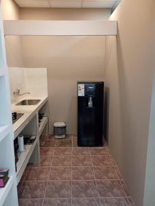 a black refrigerator in a room with a sink at Alojamiento Gral Alvear in General Alvear +17 photos