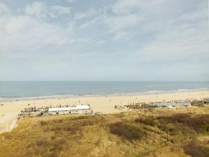 a view of a beach with people on it at Carlton Beach in Scheveningen