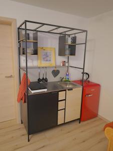 a small kitchen with a sink and a shelf at elfA-partment in Schwanstetten +13 photos