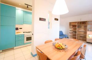 a kitchen with a wooden table with a bowl of fruit on it at Il Porto trilocale nr.7 in Porto Azzurro