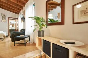 a living room with a counter with a potted plant at Residence "Professor's nest" - Verona Apartments in Verona